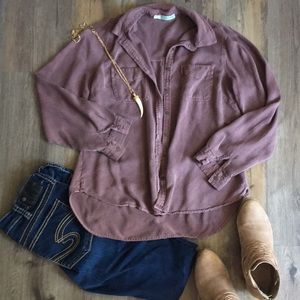 Maurice’s dark button up shirt